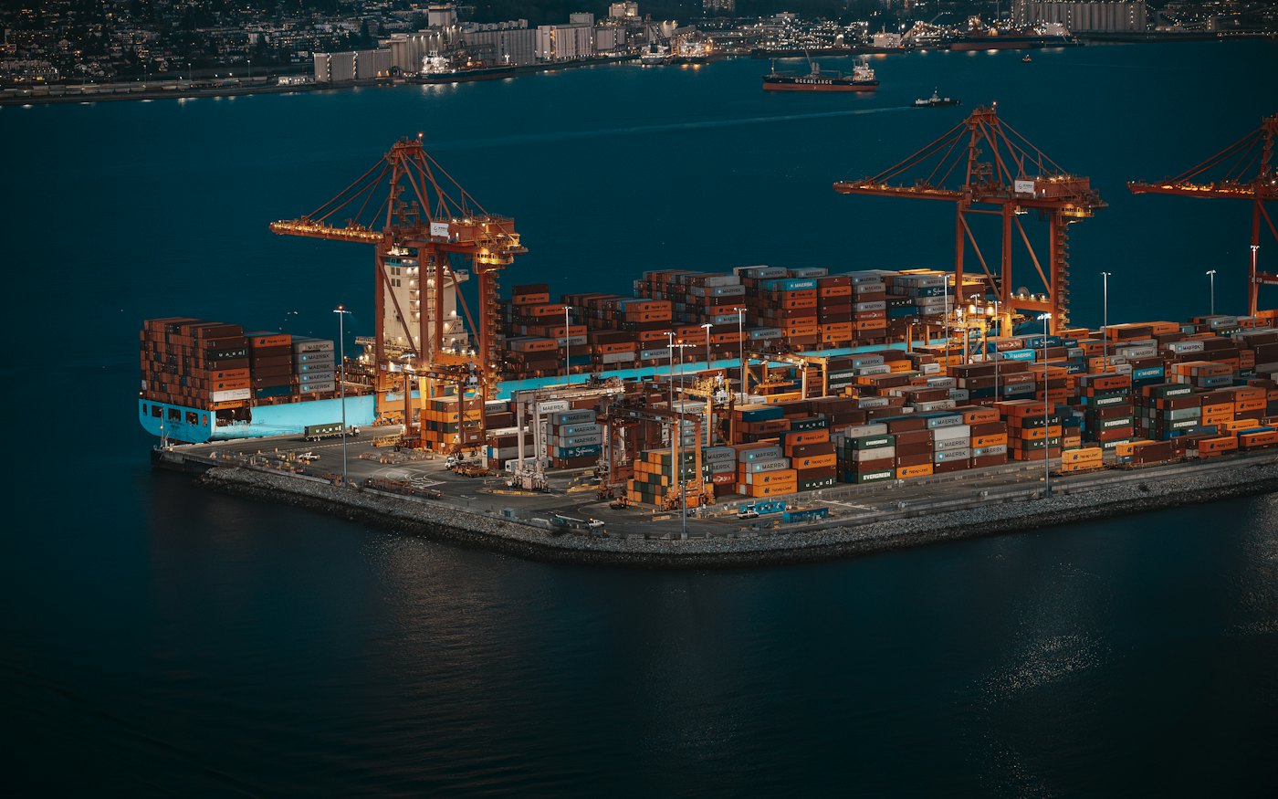 Aerial view of a container terminal with cranes and stacked shipping containers