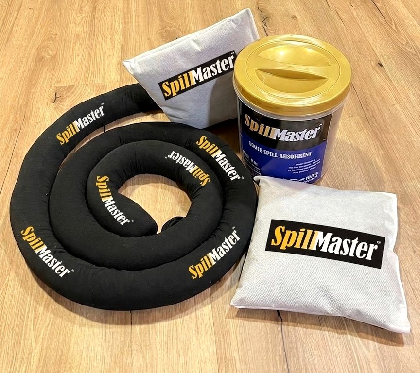 SpillMaster branded spill absorbent products: a coiled absorbent sock, two absorbent pillows and a tub of loose absorbent